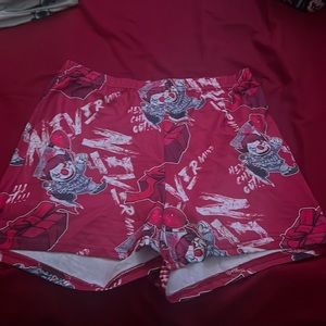 White and red graphic shorts that reach mid or less thigh
